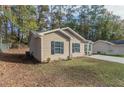 Side view of house, showcasing the neutral color scheme and landscaping at 7133 Pineview Sw Dr, Covington, GA 30014