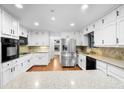 Bright kitchen featuring stainless steel appliances and granite countertops at 4822 Tomahawk Sw Ct, Lilburn, GA 30047