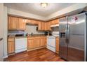 Galley kitchen with wood cabinets, stainless steel appliances, and hardwood floors at 5597 Marbut Rd, Lithonia, GA 30058