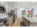 Modern kitchen with gray cabinets, granite counters and island at 5857 Silver Lake Dr, Mableton, GA 30126