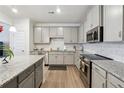 Modern kitchen with gray cabinets, granite counters, and stainless steel appliances at 5857 Silver Lake Dr, Mableton, GA 30126