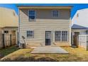 The back of the home has a concrete patio and a door, and is surrounded by a wooden fence at 128 Prity Ct, Mcdonough, GA 30253