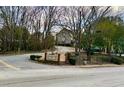 A community entrance sign surrounded by a lush landscape and tall bare trees during winter at 5 Belmonte Sw Ct, Atlanta, GA 30311