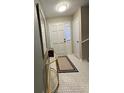 Bright foyer featuring stylish tiling, a decorative mirror, and a classic front door at 5 Belmonte Sw Ct, Atlanta, GA 30311