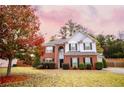 Two-story brick home with gray siding, landscaped lawn, and attached garage at 4126 Mcbride Dr, Powder Springs, GA 30127