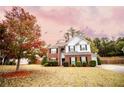 Two-story brick home with gray siding, landscaped lawn, and attached garage at 4126 Mcbride Dr, Powder Springs, GA 30127