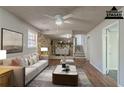 Virtually staged living room with stone fireplace and hardwood floors at 8652 Embrey Dr, Jonesboro, GA 30236