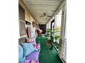 Spacious screened-in porch with seating and potted plants at 985 Farrington Se Pl, Atlanta, GA 30315