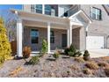Covered front porch with white columns and landscaping at 1076 Allspice Way, Lawrenceville, GA 30045