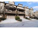Row of townhouses with attached garages, balconies, and trees at 3204 Saute Way, Avondale Estates, GA 30002