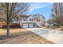 Charming two-story home with attached two-car garage and inviting elevated porch and a long concrete driveway at 118 Gilberts Way, Temple, GA 30179