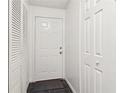 Bright entryway featuring a white door, tile floor, and multiple storage closets at 1525 Terrell Mill Se Pl # A, Marietta, GA 30067