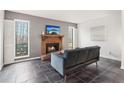 Living room with gray walls, tile floors, and a fireplace with wood mantel at 1525 Terrell Mill Se Pl # A, Marietta, GA 30067