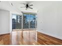 Spacious bedroom features hardwood floors, a ceiling fan, and a balcony overlooking the city at 1080 Peachtree Ne St # 1906, Atlanta, GA 30309