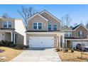 Attractive two-story home featuring a brick facade, two-car garage, and manicured front yard at 4722 Blake Loop, Atlanta, GA 30349