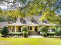 House exterior showcasing a charming two-story home with a wrap-around porch at 969 Knox Chapel Rd, Social Circle, GA 30025