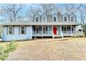 Two-story home with a red front door and a wraparound porch at 3898 Buckland Dr, Lilburn, GA 30047