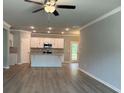 Open concept living room with hardwood floors and ceiling fan at 3875 Shelleydale Dr, Powder Springs, GA 30127