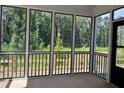 Spacious screened porch overlooking wooded backyard at 3875 Shelleydale Dr, Powder Springs, GA 30127