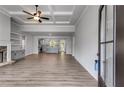 Spacious living room featuring an open floor plan, trey ceiling, and stone fireplace at 8981 Callaway Dr, Winston, GA 30187