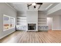 Inviting living room boasts a stone fireplace, custom built-ins, and recessed lighting at 8981 Callaway Dr, Winston, GA 30187