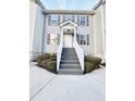 Two-story townhome with gray siding, gray stairs, and landscaping at 420 Old Holcomb Bridge Rd, Roswell, GA 30076