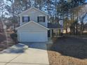 Two-story house, tan siding, white garage door, and sunny day at 10411 Ivygate Ter, Jonesboro, GA 30238