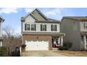 Two-story home with a white garage door and well-maintained landscaping at 135 Cessna Dr, Canton, GA 30114