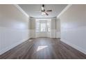 Living room with hardwood floors, bay window and ceiling fan at 5590 Vickery Cir, Cumming, GA 30040