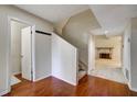 Foyer featuring wood floors, coat rack and staircase with easy access to the fireplace and living room at 104 Woodhaven Way, Alpharetta, GA 30009