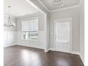 Bright dining room with hardwood floors, wainscoting, and a chandelier at 505 Paces Dr, Lithia Springs, GA 30122