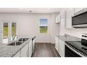Modern kitchen with granite countertops and stainless steel appliances at 175 Amberjack Trail, Covington, GA 30016