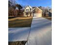 Charming two-story home with a well-manicured lawn and a long driveway at 2180 Highridge Point Dr, Lithia Springs, GA 30122