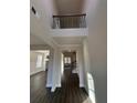 Bright, two-story foyer showcasing wood floors and staircase access to the second floor at 2180 Highridge Point Dr, Lithia Springs, GA 30122