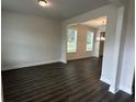 Spacious living area featuring elegant hardwood flooring and large windows, perfect for entertaining and relaxation at 2180 Highridge Point Dr, Lithia Springs, GA 30122