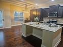 Modern kitchen featuring granite countertops and dark cabinetry at 2368 Misty Ivy Ct, Buford, GA 30519