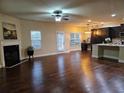 Spacious living room with hardwood floors, fireplace, and access to backyard at 2368 Misty Ivy Ct, Buford, GA 30519