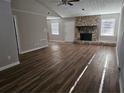Spacious living area featuring elegant hardwood floors and a cozy stone fireplace at 432 Independence Dr, Jonesboro, GA 30238