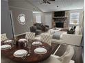 Open living space with stylish furniture, stone fireplace, and adjacent dining area at 432 Independence Dr, Jonesboro, GA 30238