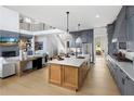 Modern kitchen with light wood cabinetry, white countertops, and island at 6430 Pond View Dr, Cumming, GA 30028