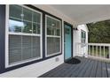 Quaint front porch with teal door and white railings at 235 Holly Nw Rd, Atlanta, GA 30314