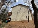 The backside of a tan two story townhome with a wooden porch at 2912 Ashlyn Pointe Dr, Atlanta, GA 30340