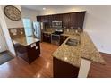 Modern kitchen features granite countertops, stainless appliances, and hardwood floors at 2912 Ashlyn Pointe Dr, Atlanta, GA 30340