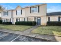 Tan siding townhouses with blue doors and landscaping at 319 Quincy Ave, Mcdonough, GA 30253
