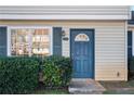 Blue front door entry to a tan-sided townhouse at 319 Quincy Ave, Mcdonough, GA 30253