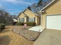 House exterior showcasing walkway, landscaping, and attached garage at 752 Bostonian Way, Lawrenceville, GA 30046