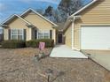 House exterior showcasing walkway, landscaping, and attached garage at 752 Bostonian Way, Lawrenceville, GA 30046