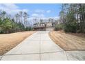 Long driveway leading to a two-story house at 1005 Greenridge Trl, Loganville, GA 30052