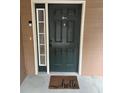 Dark green front door with a welcome mat at 3500 Sweetwater Rd # 424, Duluth, GA 30096