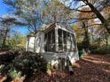 Side view of a white brick house with a screened porch at 1814 N Druid Hills Ne Rd, Brookhaven, GA 30319
